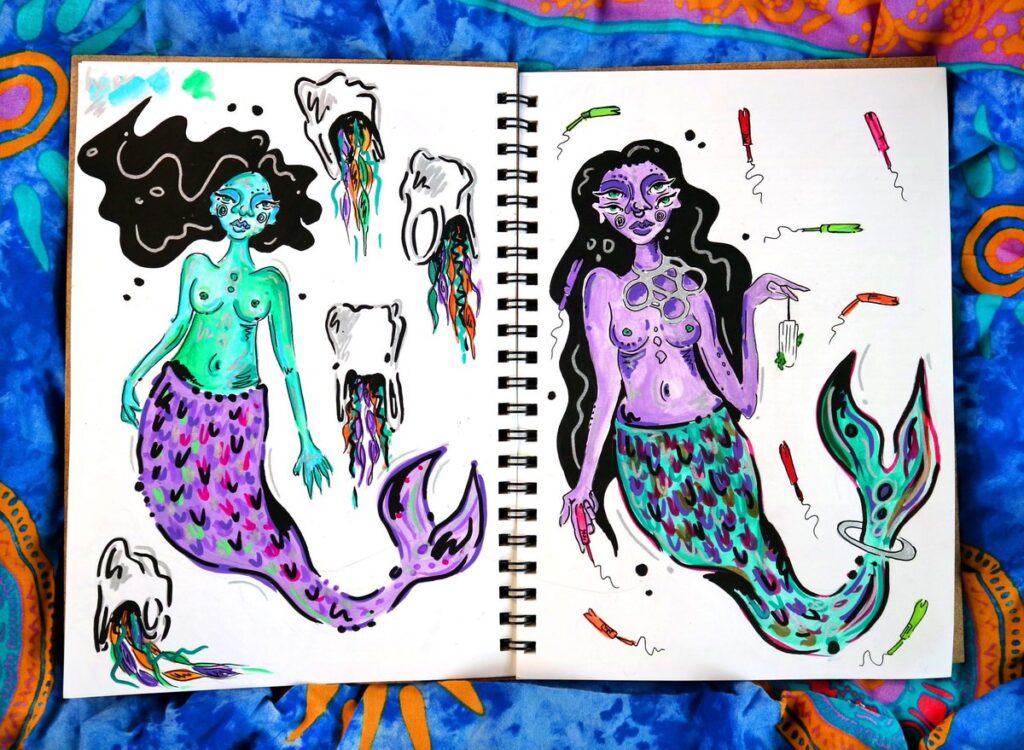 Drawings of mermaids with rubbish around them