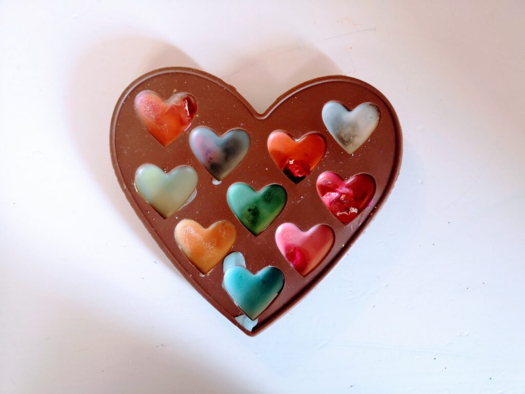 A hearts shaped mould full of melted wax crayons